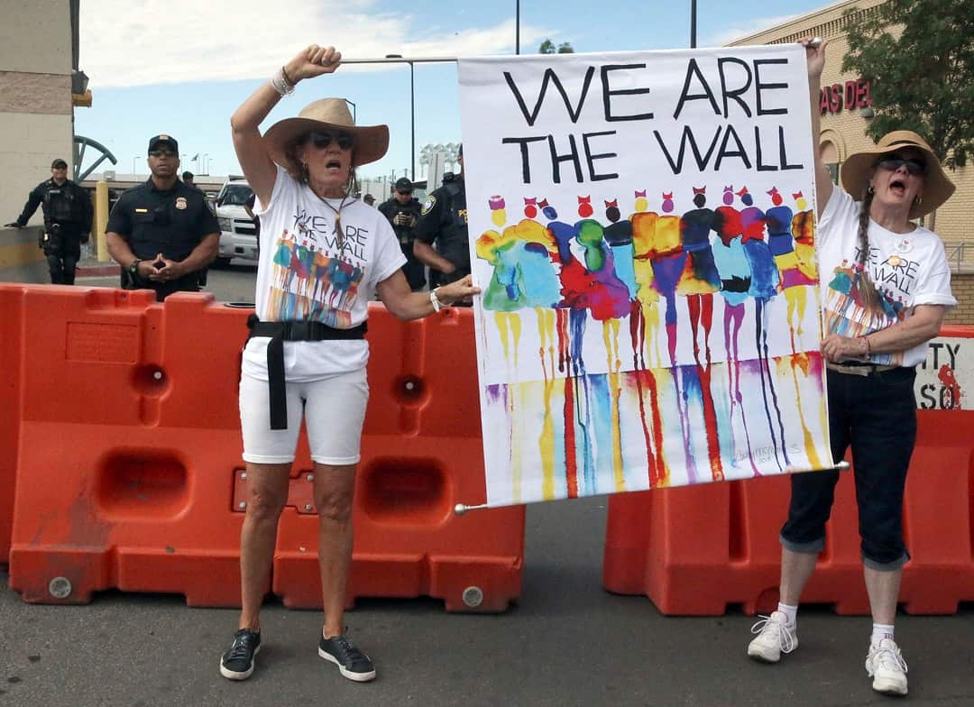 US Border Protection officers watch on as demonstrators protest immigration policy outside the Paso Del Norte International Port of Entry in downtown El Paso.