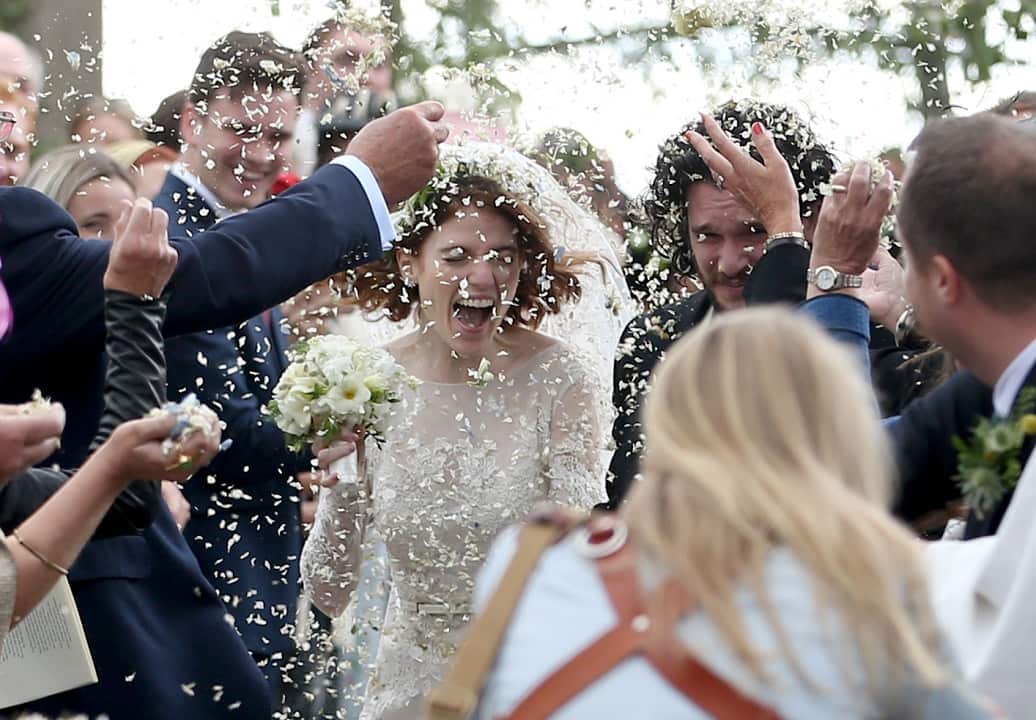 Kit Harington and Rose Leslie get covered in confetti after their wedding.