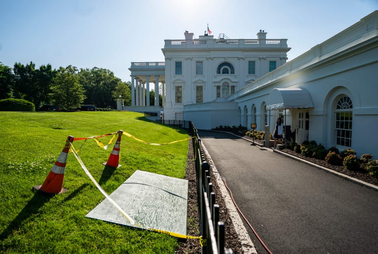 A wooden board covers a sinkhole on the North Lawn of the White House, just outside the press briefing room in Washington, DC, USA, 23 May 2018.
