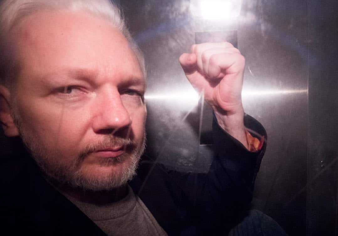 Wikileaks co-founder Julian Assange, in a prison van, as he leaves Southwark Crown Court in London, Britain (AAP)