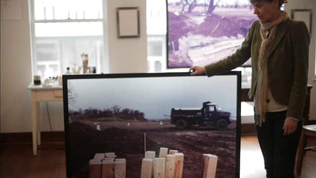Campaigner and photographer Melinda Hunt with one of the pictures from Hart Island.