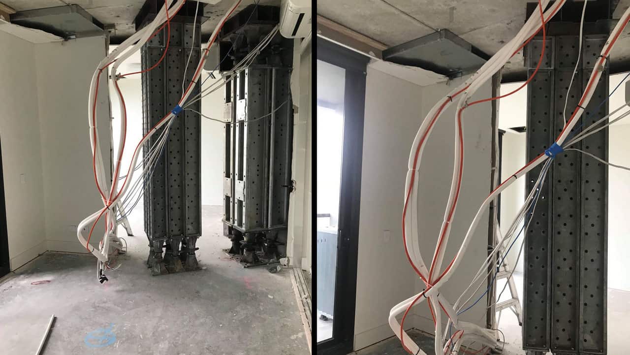 An apartment in the cracked Opal Tower in Sydney Olympic Park, that shows the ceiling and flooring removed and propping equipment installed.