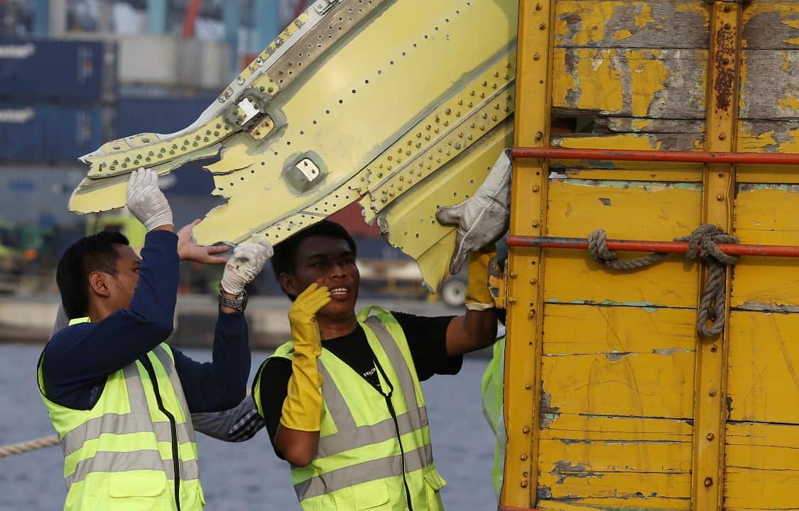 Officials move pieces of wreckage from the crashed Lion Air jet for further investigation.