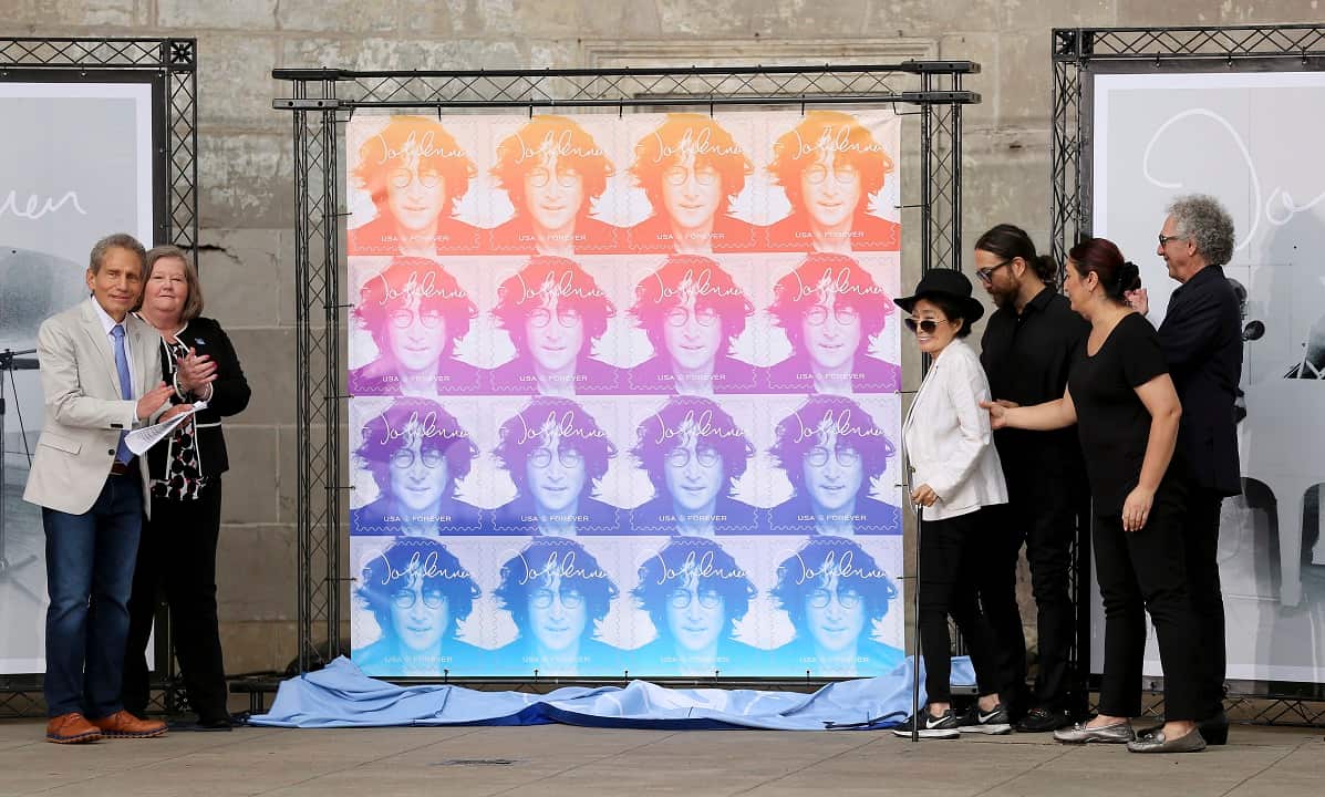 Yoko Ono, fourth from right, unveils the John Lennon Commemorative Forever stamp.