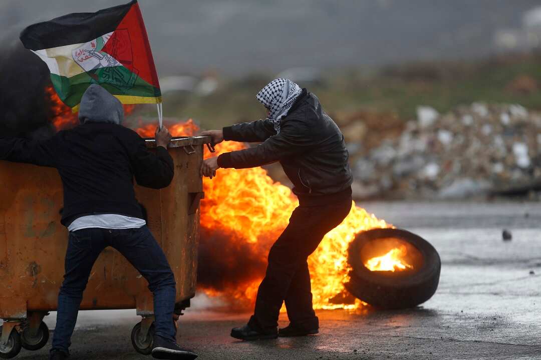 Palestinians clash with Israeli troops following a protest against a US President Mike Pence.