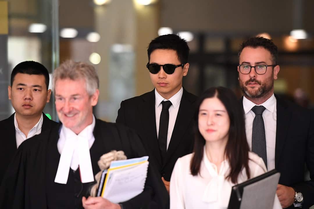 Chinese actor Yunxiang Gao (centre) leaves the Downing Centre court in Sydney, Friday, January 25, 2019. (AAP Image/Joel Carrett) NO ARCHIVING