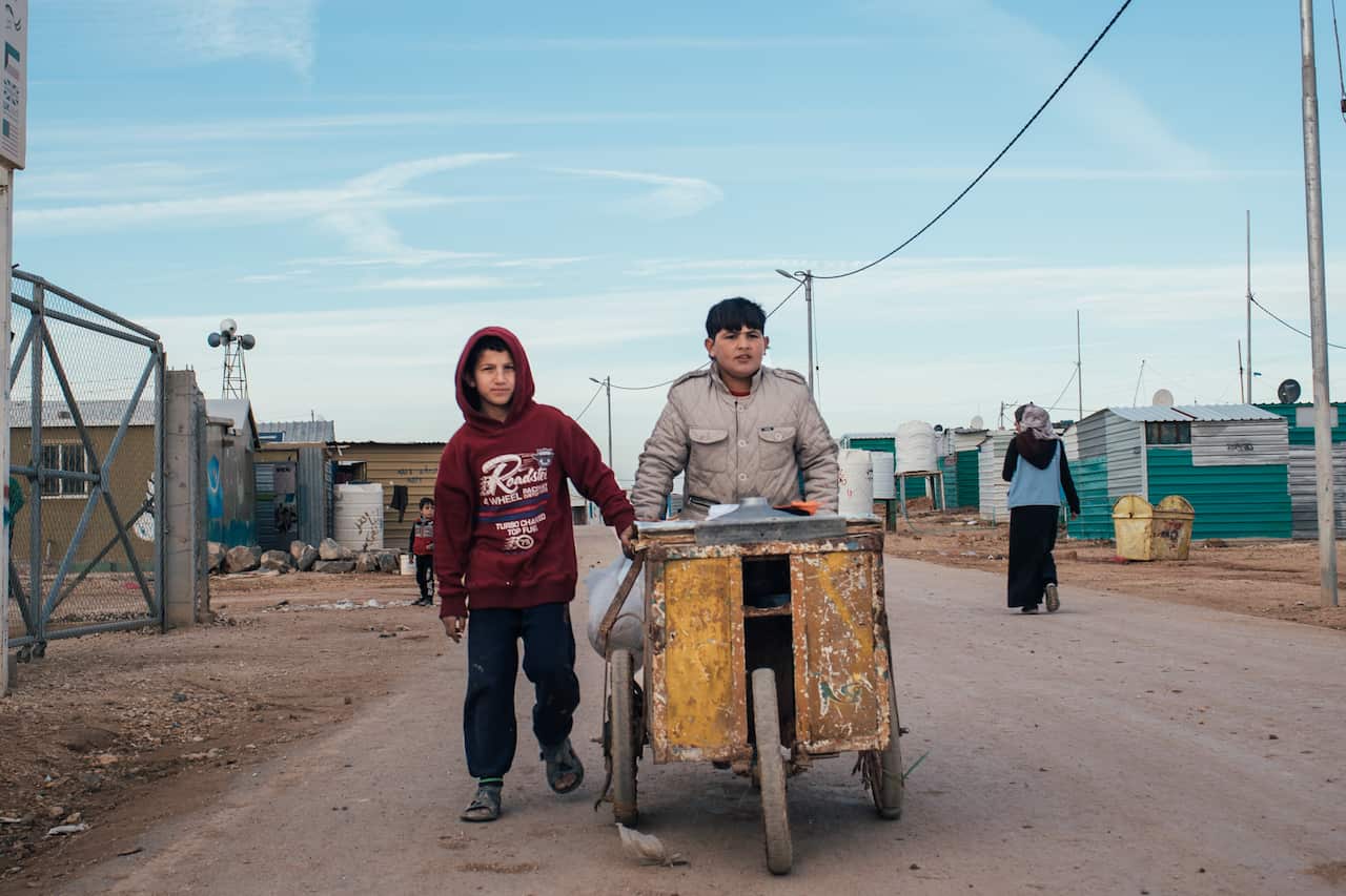 12-year-old cousins Waled and Khalil selling corn in the Zaatari camp.