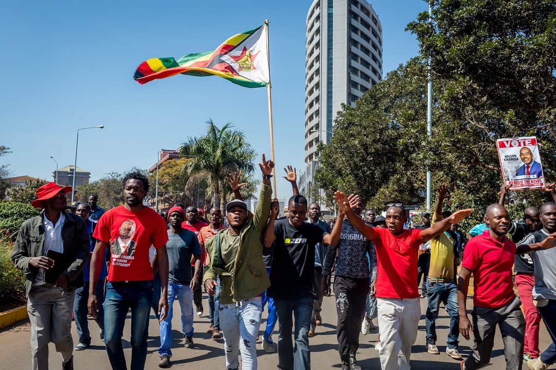 MDC Alliance supporters protest the vote count outside the Rainbow Towers in Harare.
