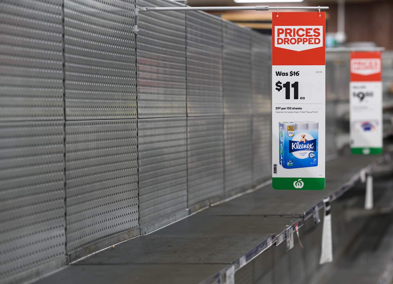 Empty shelves normally stocked with toilet paper rolls at Woolworths Supermarket.
