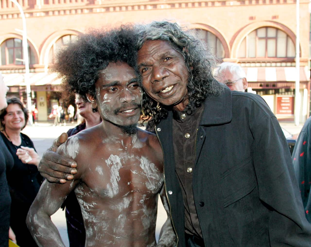 David Gulpilil hugs his son Jamie at movie premiere.
