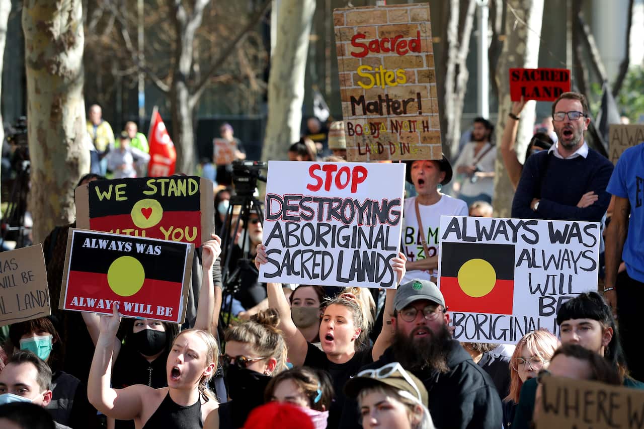Protesters are seen during a rally outside the Rio Tinto office in Perth in June 2020, after the mining giant destroyed the sacred Juukan Gorge caves.
