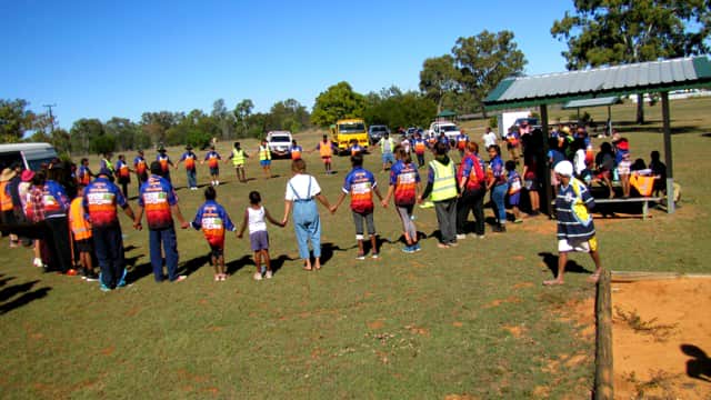 The Darumbul community forms a circle of thanks during NAIDOC Week.