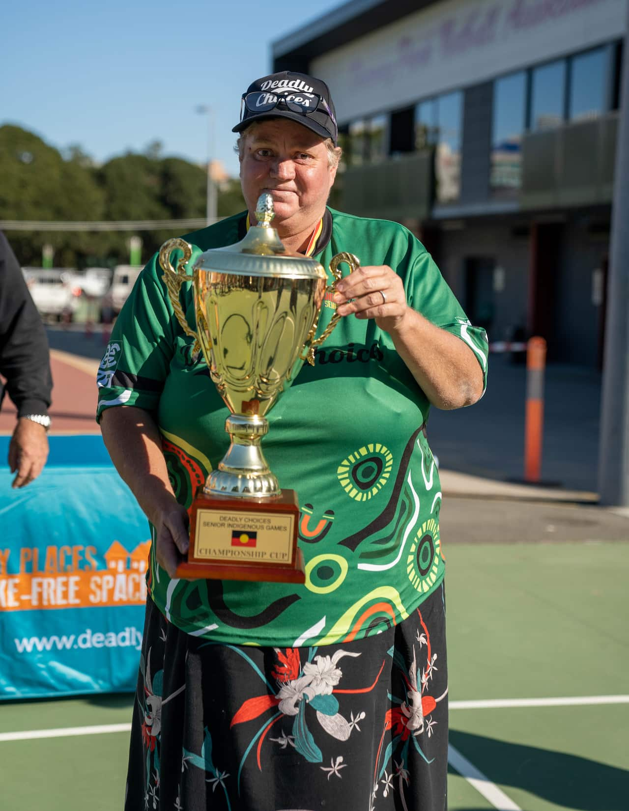 A woman holding up a trophy