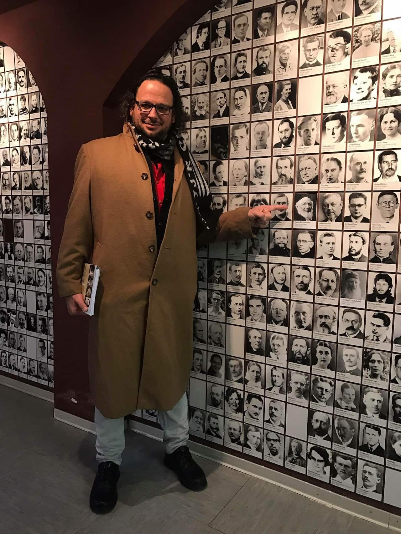 Professor Ghil'ad Zuckermann pointing at a photo of  Revd Clamor Wilhelm Schürmann