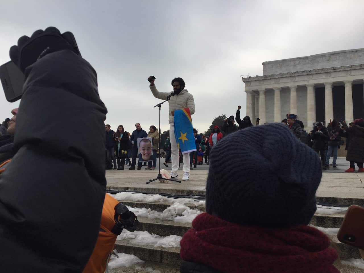 Australian Heritier Lumumba, a former AFL footballer of Brazilian and Congolese descent, addresses the gathering at the Indigenous Peoples March.
