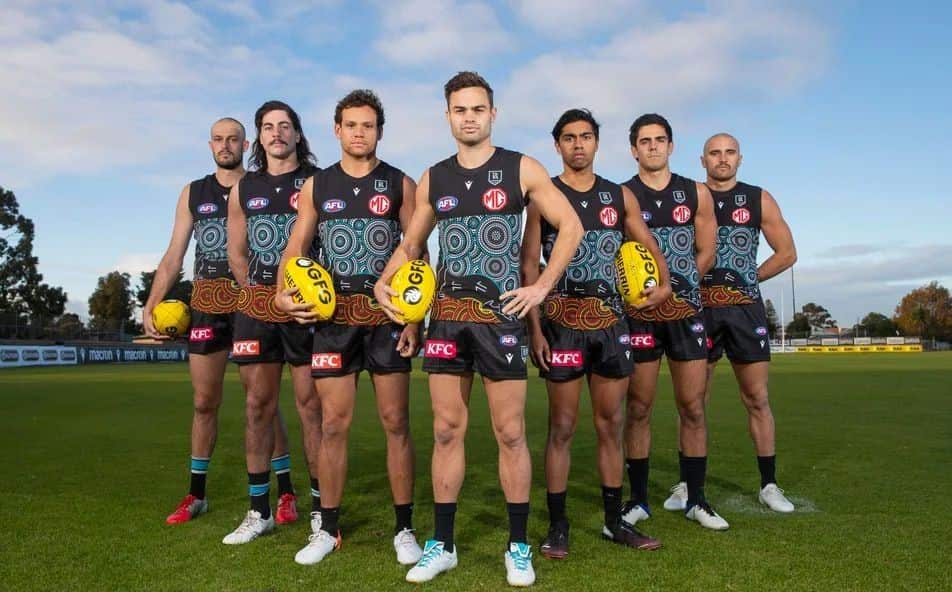 Port Adelaide model their guernsey.