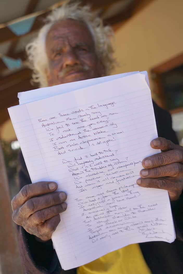 Riverbank Frank holding the poem he wrote for the R U OK event in Bourke, NSW