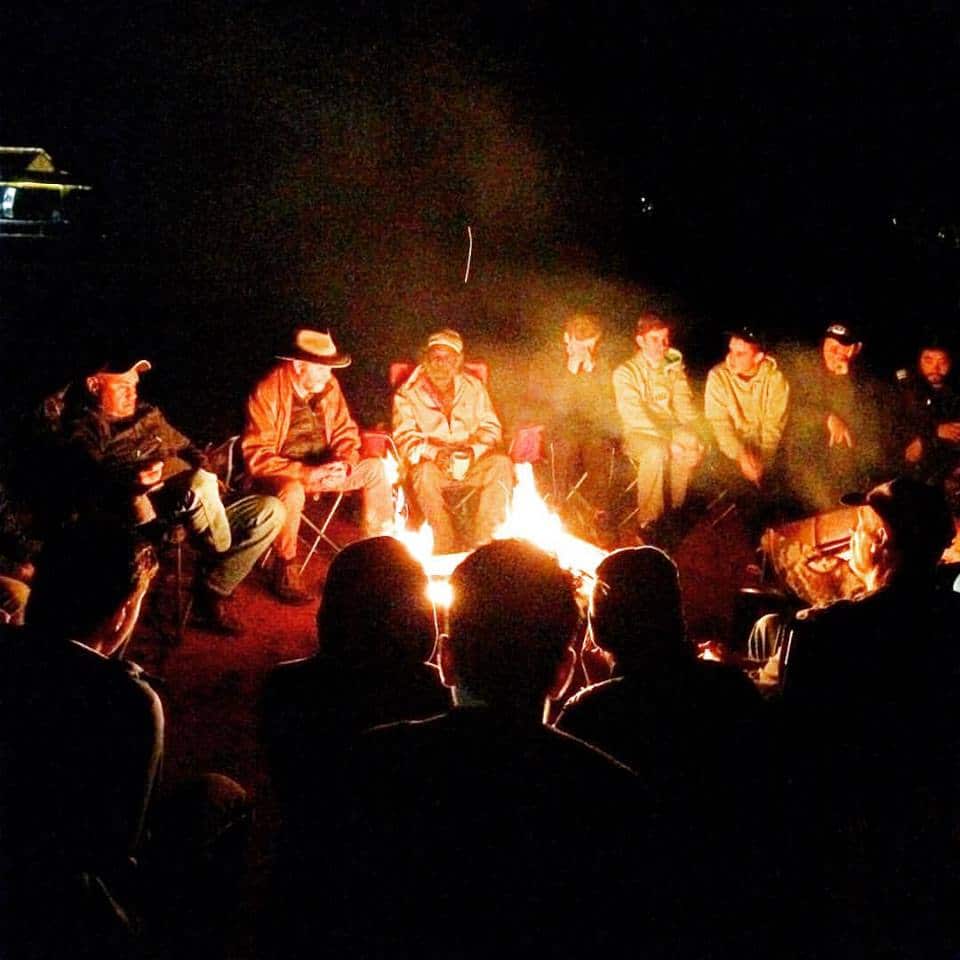 Elders in Central Australia yarn around a campfire. 
