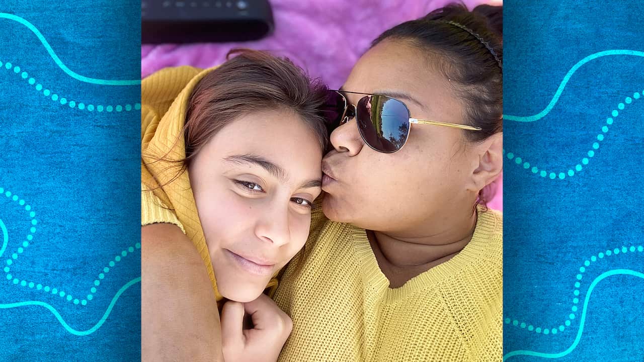 Ursula yovich kisses her daughter djarla on the head.
