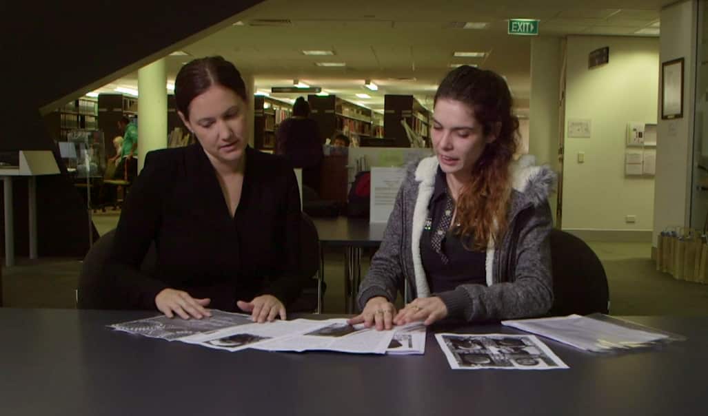 Monak Morris (right) shows her family history research to NITV journalist Ella Archibald-Binge
