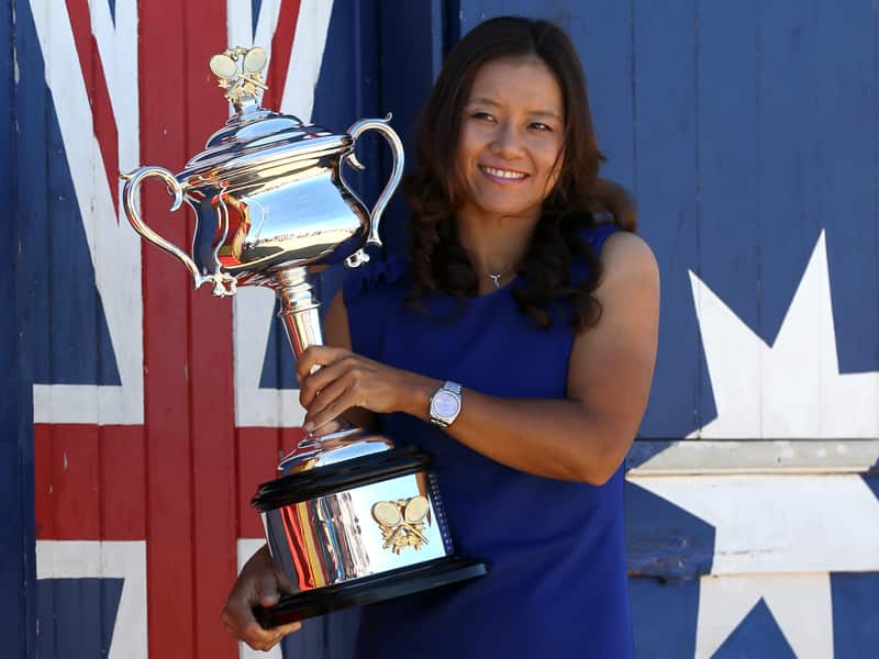 China's Li Na posing for photos at Brighton Beach with her Australian Open trophy in 2014.