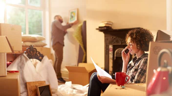 A young couple move into their new home and start to unpack