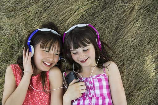 Girls lying down listening to headphones