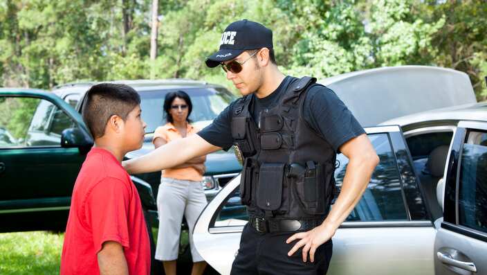 Policeman questioning witnesses during crime investigation