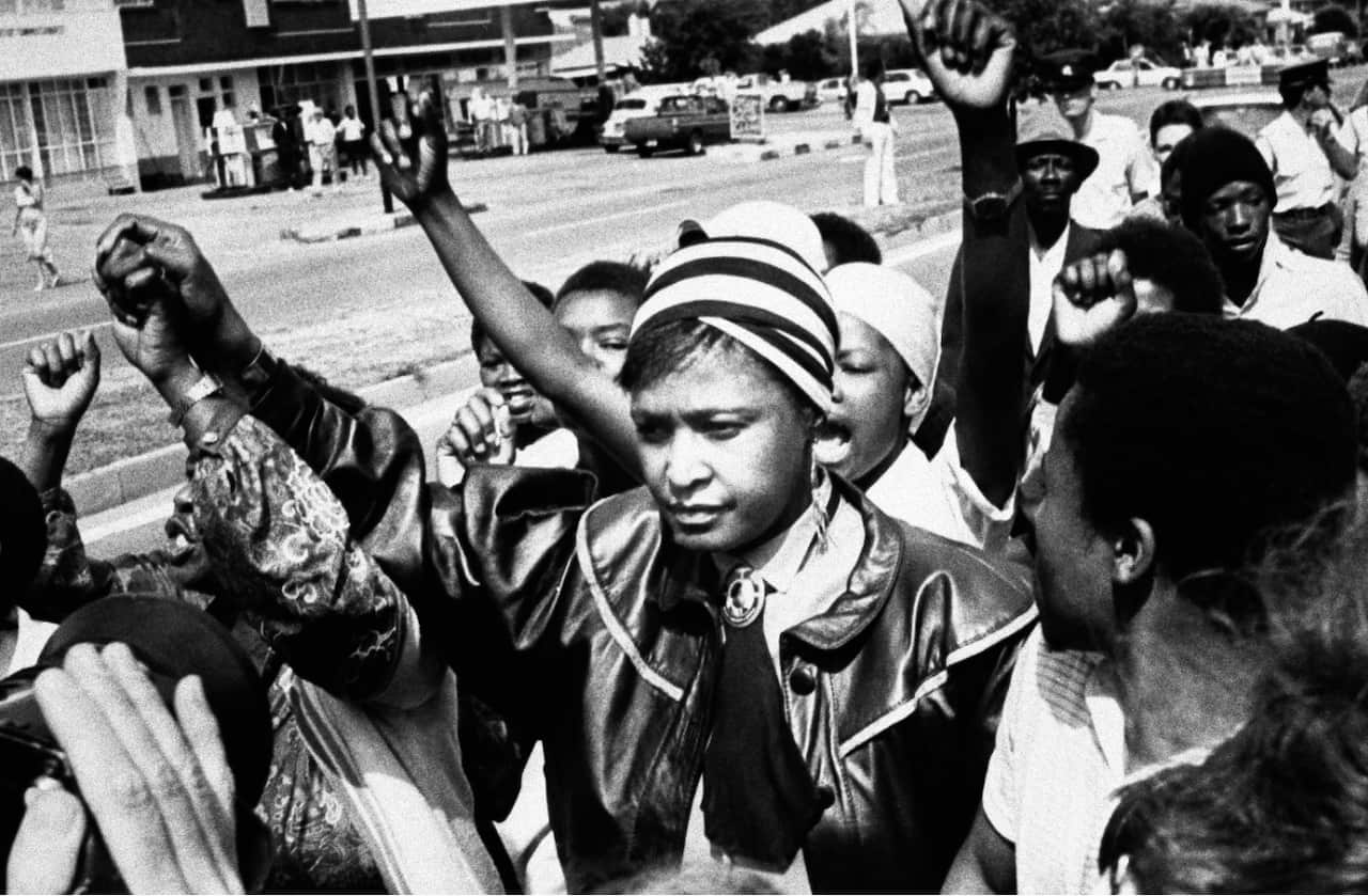 Winnie Mandela is cheered by supporters after appearing in the Krugersdorp Magistrate's court