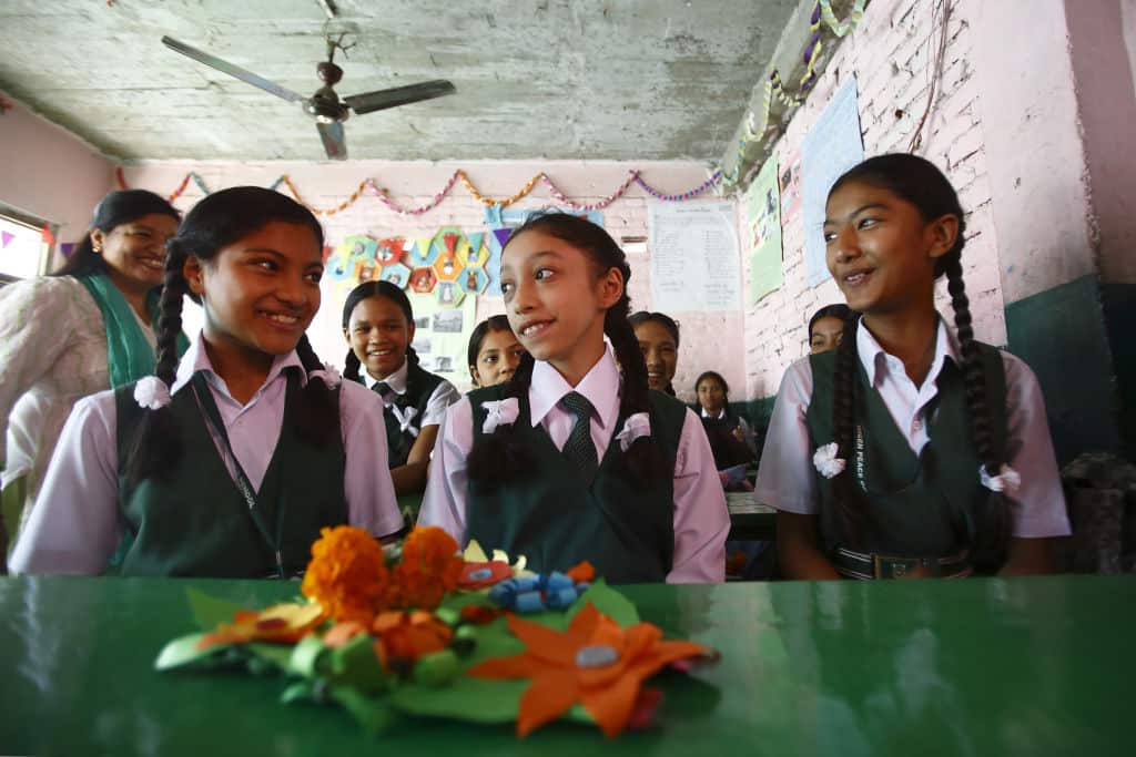 Nepal's former living goddess Matina Shakya (centre) sits in a classroom on her first day of school in Kathmandu on October 9, 2017.        