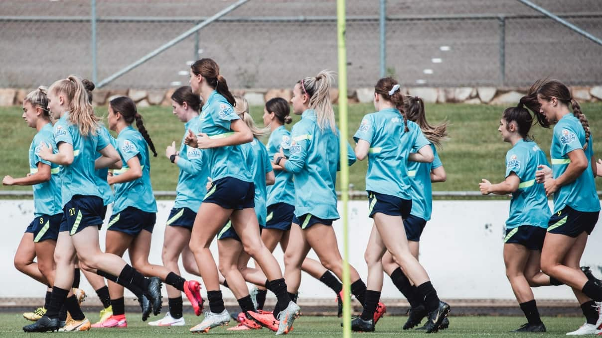 Players jog around the field during the Women's Talent Identification Camp