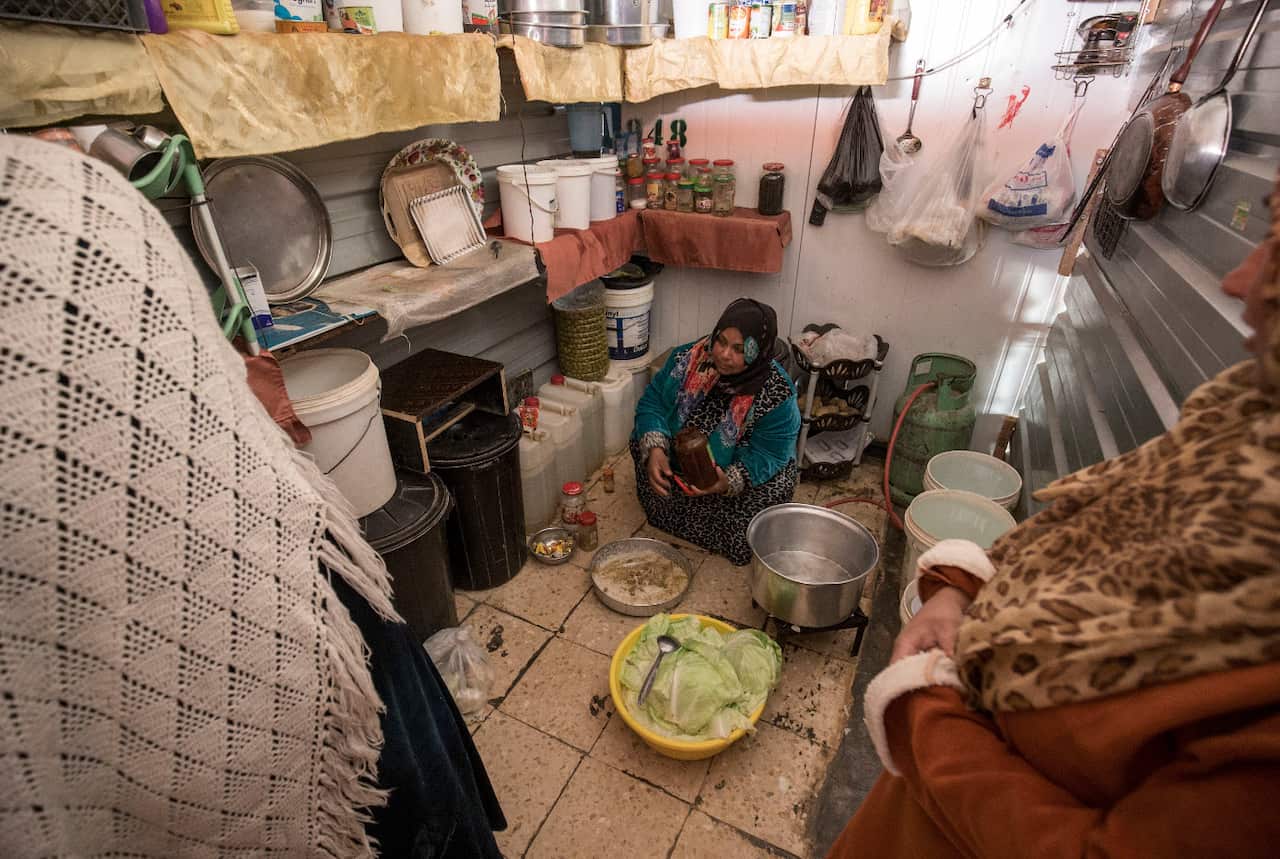 Um Ala’a and her friends preparing malfouf, a traditional Middle Eastern dish of cabbage leaves stuffed with spiced rice and mince meat. 