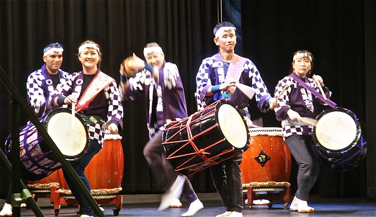 Toshinori Sakamoto (front right), the founder of a Melbourne-based taiko group Wadako Rindo, plays okedo daiko on stage