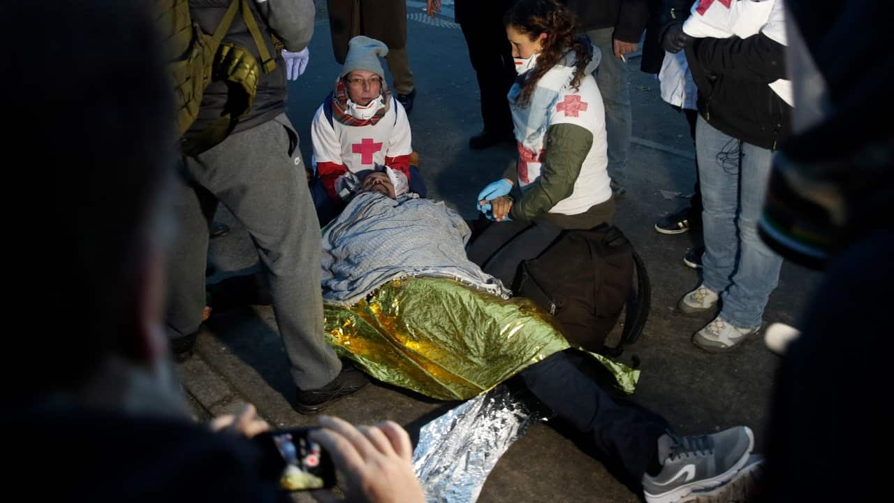 Street medics tend to an injured person.