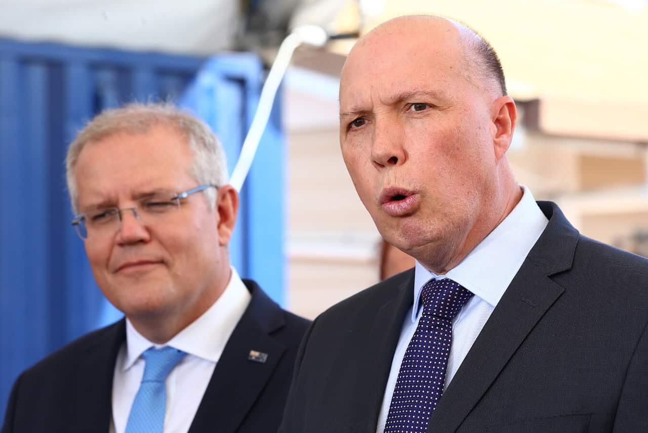 Federal Minister Peter Dutton (right) speaks to the media with Prime Minister Scott Morrison (left)