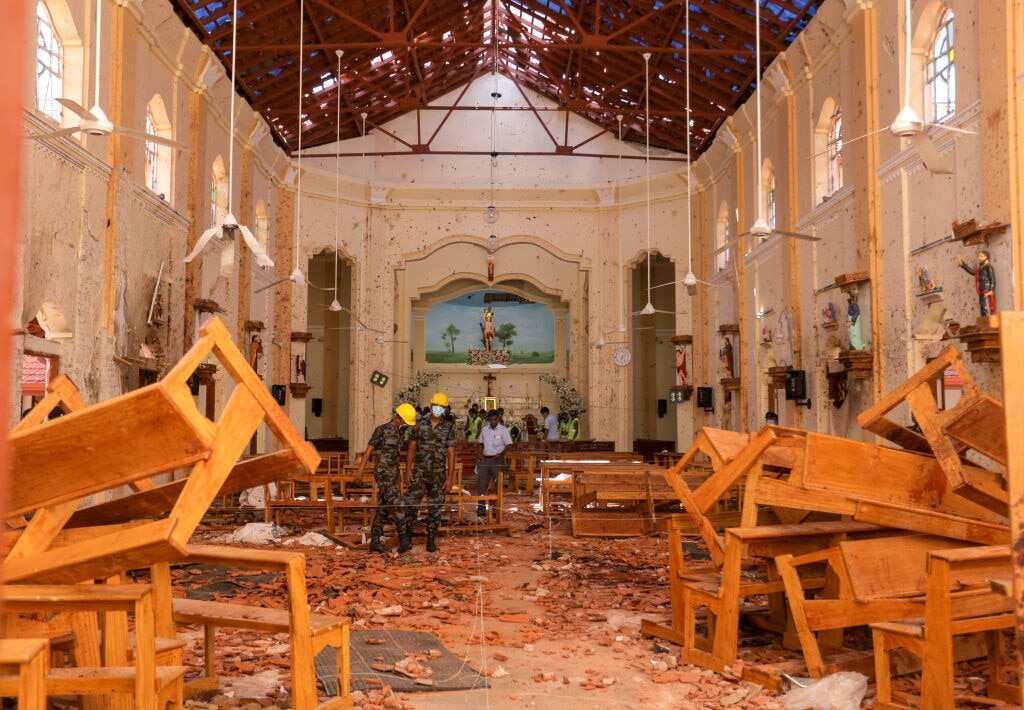 Sri Lankan military officers conduct inspections inside St. Sebastians church.