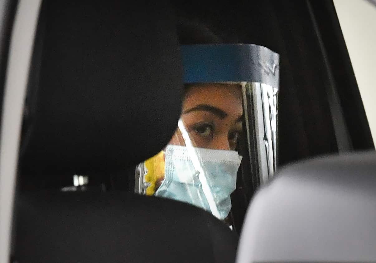 Sarah Caisip is seen wearing protective masks as she leaves the site of a funeral for her father Bernard Prendergast in Brisbane, Thursday, 10 September, 2020. 