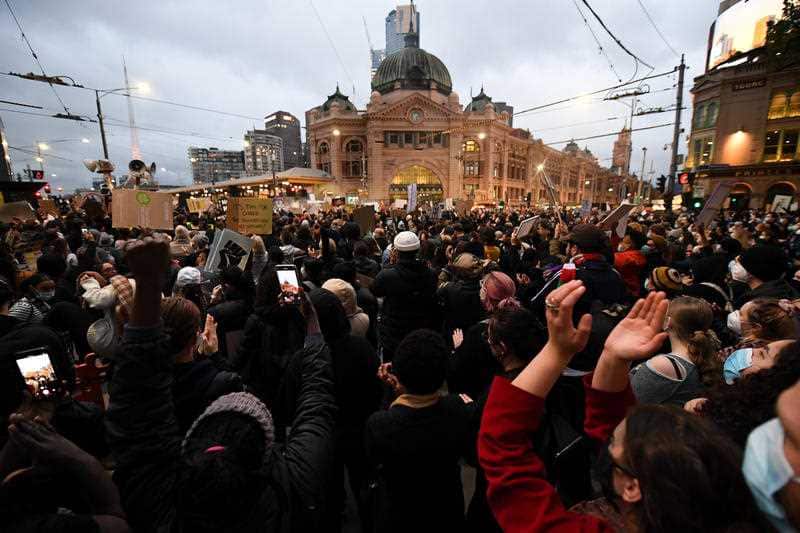 Protesters in Melbourne gather in front of Flinders Street Station