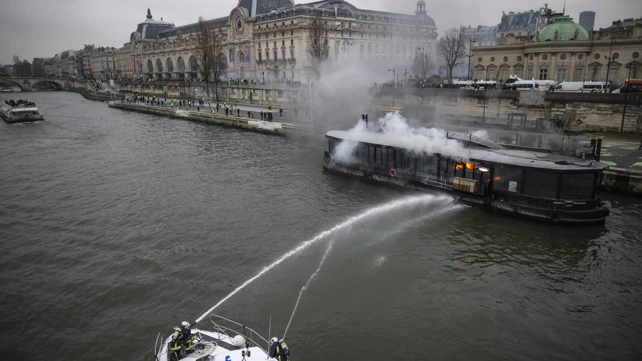 A burning boat moored next to Orsay Museum is seen during a demonstration by the "yellow vests" movement in Paris, France.