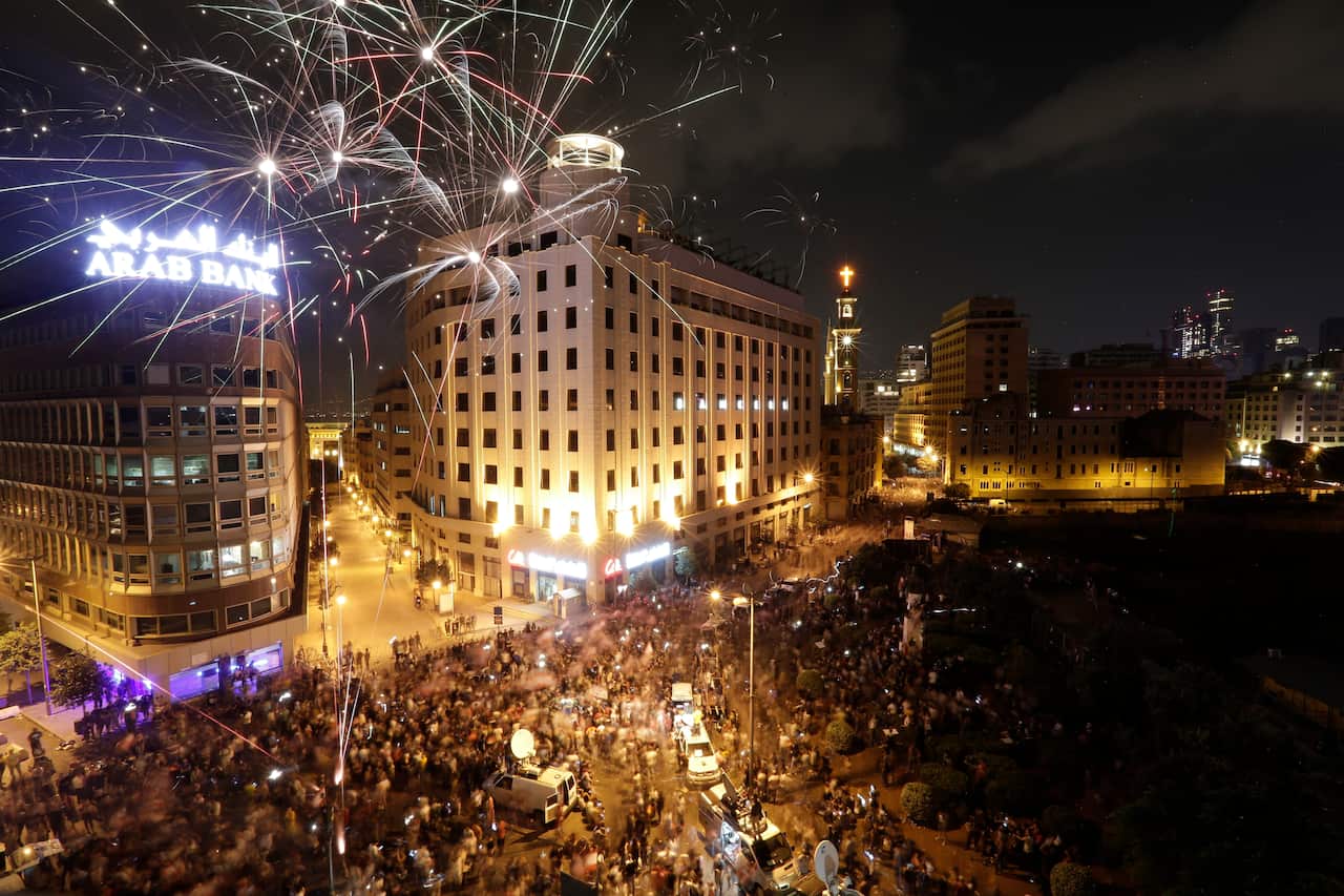 Hundreds of thousands thronged public squares across Lebanon on Sunday in the largest protests the country has seen since 2005.