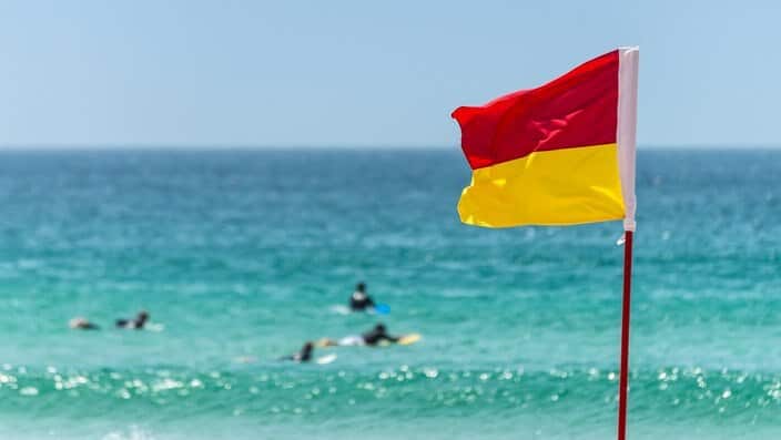 Red And Yellow Warning Sign Flag at the Beach