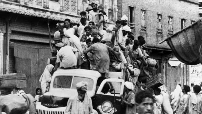 Soldiers and Crowd Piled on Top of Car