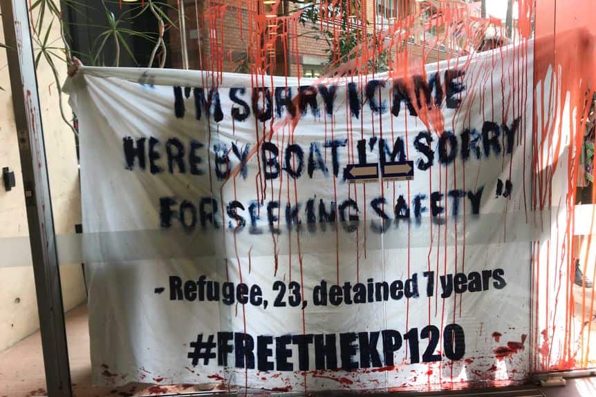 Protesters splashed red paint on windows and buildings at the University of Queensland.