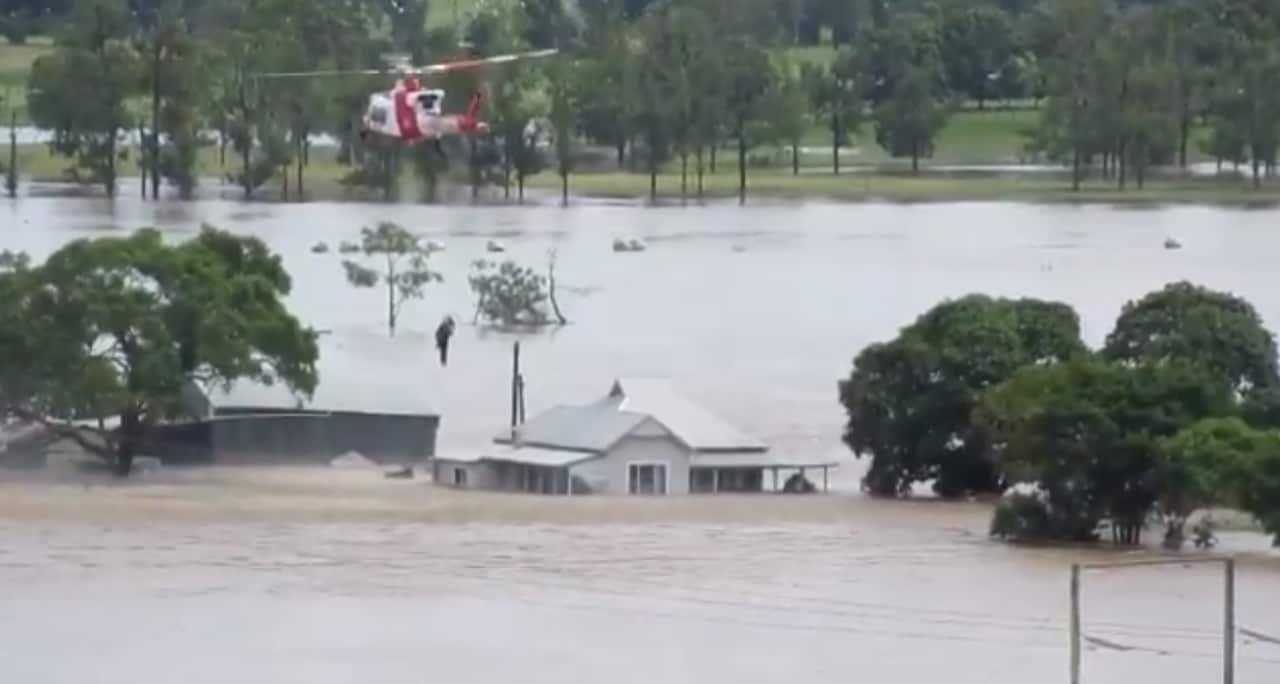 NSW RFS crews rescue people from rising floodwaters. 
