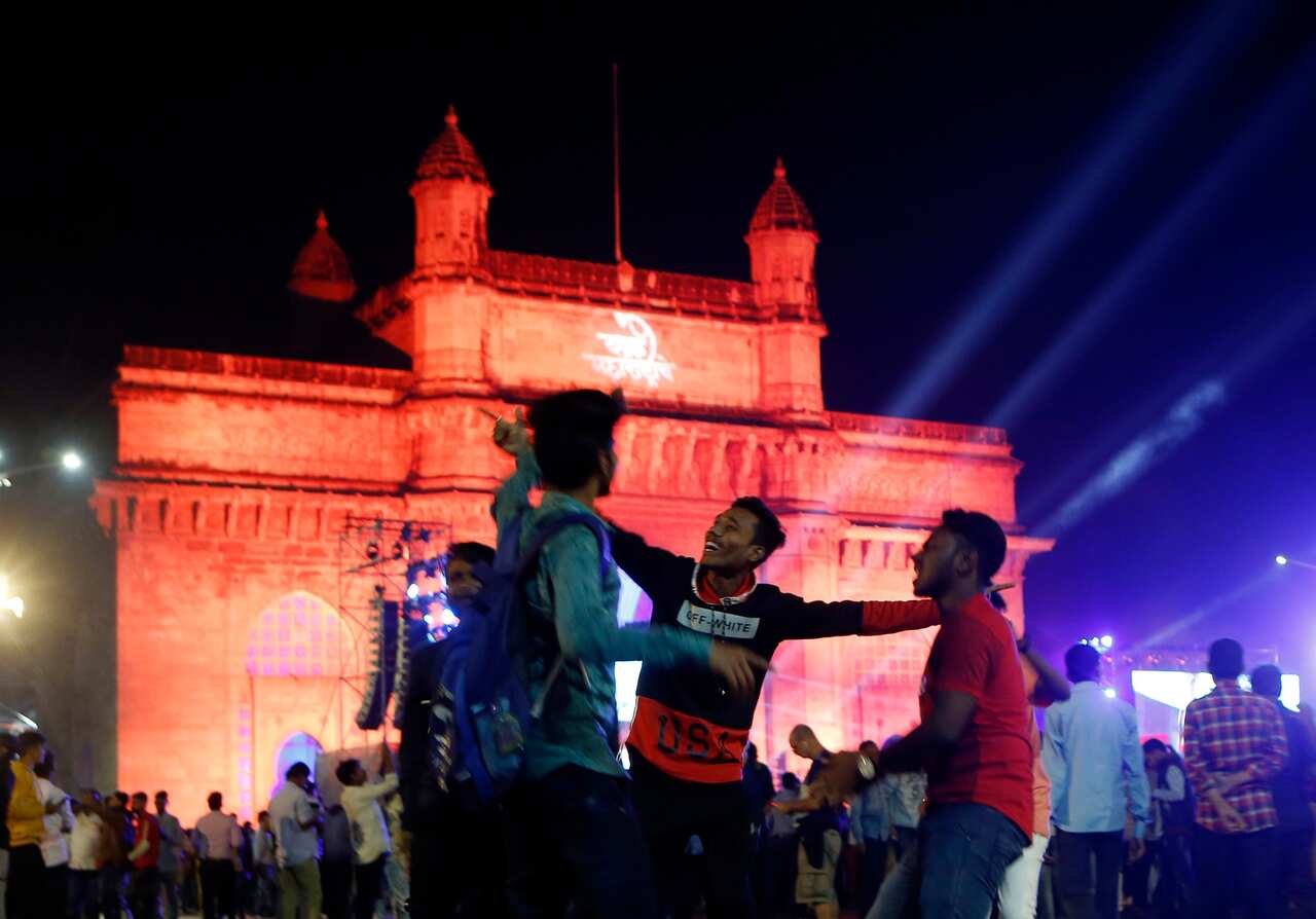 People celebrates New Year's Eve in front of the iconic Gateway of India in Mumbai, India, Tuesday, Dec 31, 2019. (AP Photo/Rajanish Kakade)
