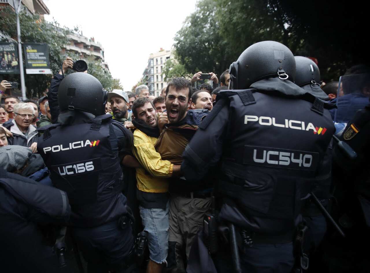 Catalan people who gathered outside the Ramon Llull school clash with Spanish National riot policemen during the '1-O Referendum' in Barcelona, Catalonia, on 01 October 2017. 