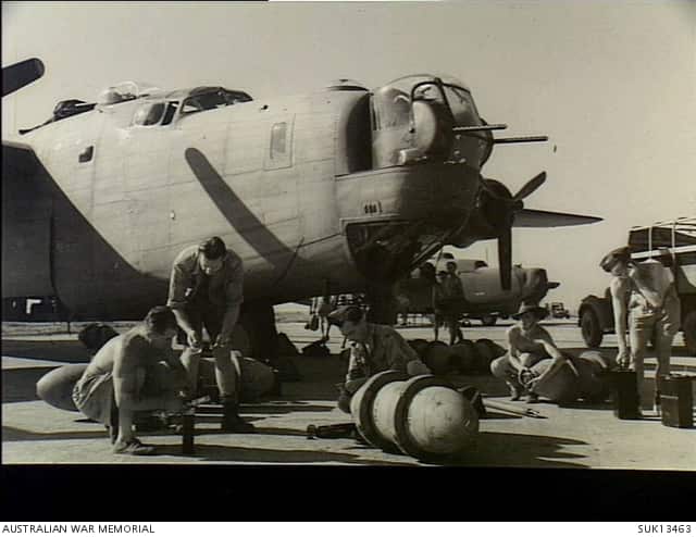 RAF Armourers preparing bombs for loading into a Liberator in readiness for a raid on Rangoon.C. 1944-11