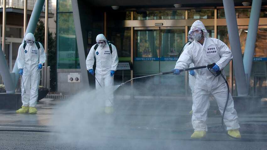 South Korean soldiers wearing protective gears spray disinfectant as a precaution against the new coronavirus in Seoul, South Korea Source: AP