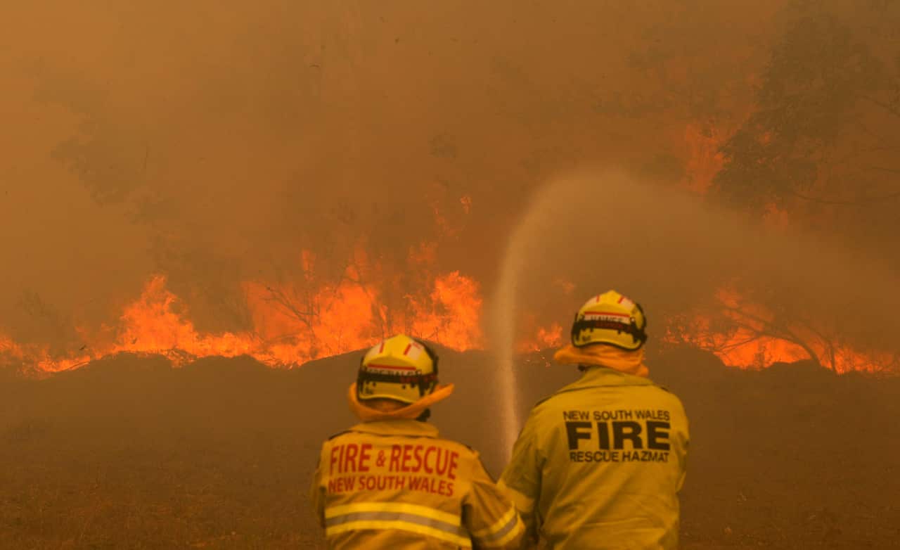 Firefighters work to contain a bushfire along Old Bar road in Old Bar, NSW, Saturday, November 9, 2019.