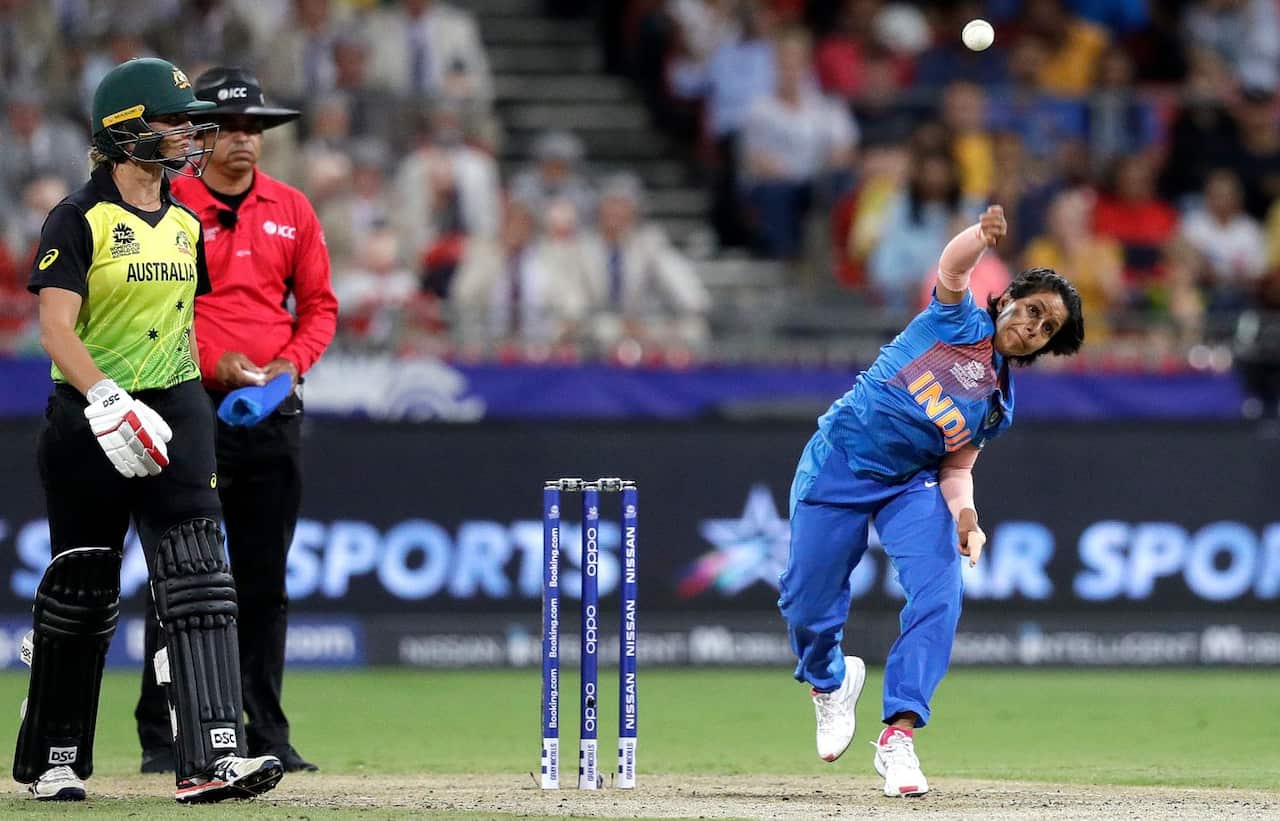 India's Poonam Yadav, right, bowls against Australia during the first game of the Women's T20 Cricket World Cup in Sydney, Friday, Feb. 21, 2020. 